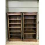 A pair of mahogany finish open book shelves with drawers to the upper frieze, ring turned