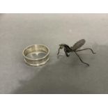A chinoiserie praying mantis in silver sheet and wire c.1945 together with a Victorian silver napkin