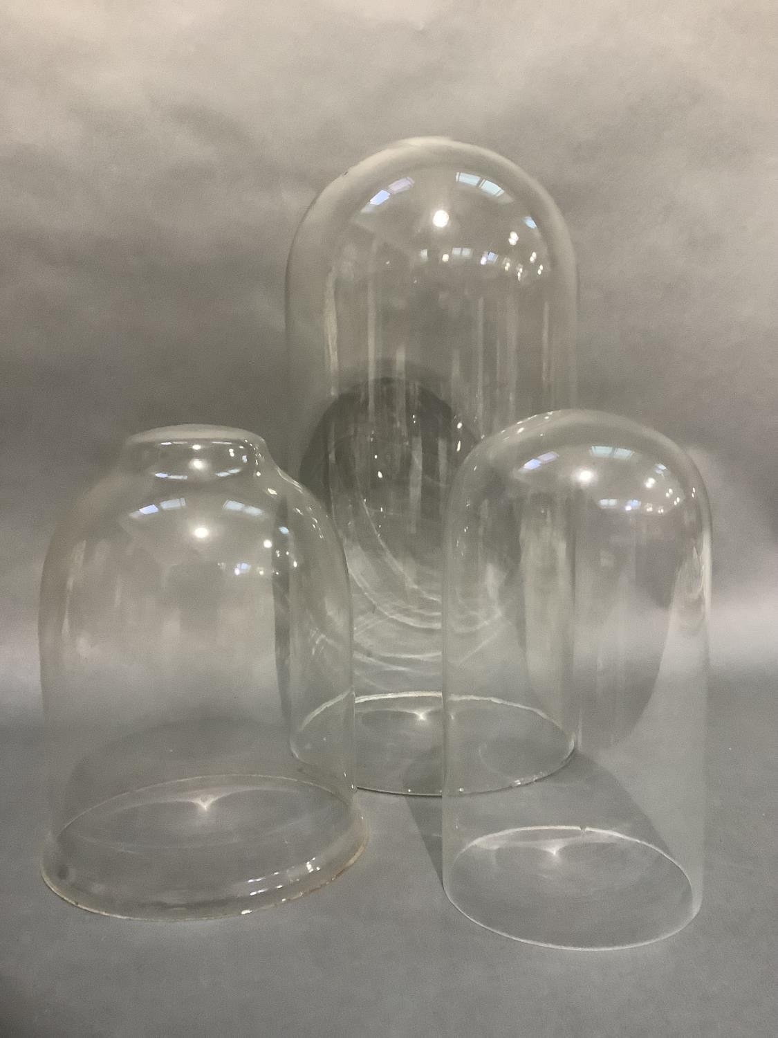Three glass domes measuring approximately 45cm, 27cm and 26cm