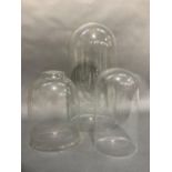 Three glass domes measuring approximately 45cm, 27cm and 26cm