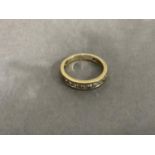 A half loop diamond ring in 9ct gold, the brilliant cut stones channel set in line, total