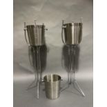 A pair of stainless steel wine coolers on stands and an extra bucket