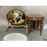 A walnut circular stand on turned legs and a mahogany oval toilet mirror