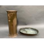 A large copper stick stand of panelled cylindrical form by Lombard England, together with a heavy