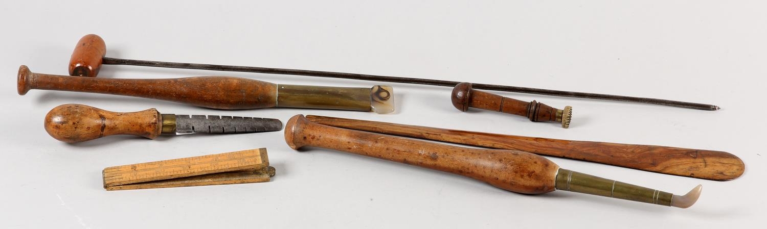 A collection of 19th century hardwood and brass mounted leather working tools, two with agate heads,
