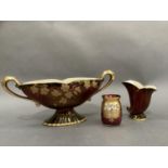 A Crown Devon ruby two handled pedestal vase, a Carlton ware rouge royale fluted vase and a ruby and