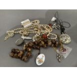 A small collection of costume jewellery including brooches and necklaces