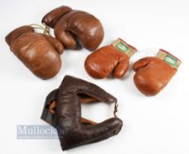 Leather Laced Boxing Gloves and Head Guard an adult's pair of gloves and an adult head guard, both
