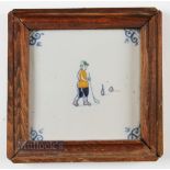 An Early 20thc Dutch Delft Kolf/Golf hand coloured painted tile - mounted in a wooden frame 6.75"