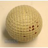 An original and unused moulded mesh small guttie golf ball - with all the original white paint -