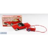 Cragstan, Japan Tinplate Ford Thunderbird with retractable top, battery operated model in red,