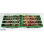 A plastic display case with 32 sections with salmon double flies, made up of stoats tail / thunder