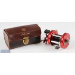 ABU Ambassadeur 6000 multiplier reel, in red, numbered to foot 010600, sliding line guide, runs