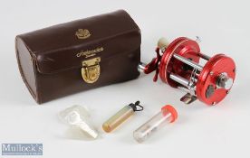 ABU Ambassadeur 6000 multiplier reel, in red, numbered to foot unnumbered, drag adjuster to end,