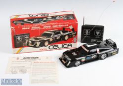 Taiyo, Japan Toyota Celica Racing Remote Controlled Car in black with racing decals, with paperwork,