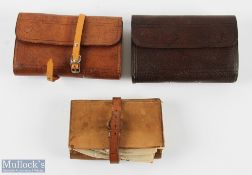 A collection of leather fly and cast wallets, all unnamed, one with flies and casts, one missing