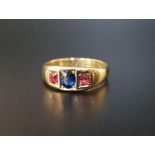 SAPPHIRE AND RUBY THREE STONE RING the central oval cut sapphire approximately 0.5cts flanked by