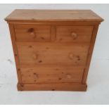 WAXED PINE CHEST with a moulded top above two short and two long drawers, standing on a plinth base,