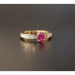 RUBY AND DIAMOND RING the central oval cut ruby approximately 0.35cts flanked by channel set