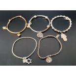 FIVE SILVER FASHION BRACELETS comprising four by ChloBo - one with filigree heart charm, one with