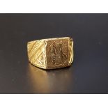 UNMARKED HIGH CARAT GOLD DRESS RING with central monogram and decorative shoulders, ring size S