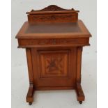 EDWARDIAN OAK DAVENPORT with a shaped and carved top above a fitted stationary box, the lift up