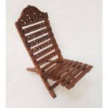 TEAK TWO PIECE CARVED LOW CHAIR with a slatted back carved with vines above a slatted seat