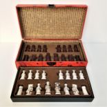 CHINESE THEMED RESIN CHESS SET of figures in white and deep red, in a fitted box with lift up lid