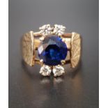 1970s SAPPHIRE AND DIAMOND DRESS RING the central round cut sapphire approximately 1.8cts, with