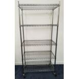INDUSTRIAL METAL RACKING with five adjustable slatted shelves, on a wheeled base, 192cm x 90cm