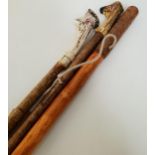 THREE CARVED WALKING STICKS two with antler handles and one with a carved grip, 115cm , 116cm and