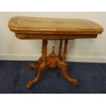 VICTORIAN WALNUT AND CROSSBANDED CARD TABLE with a rotating fold over baize lined top, on four