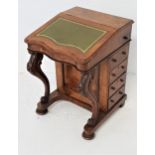 VICTORIAN WALNUT DAVENPORT with a lift up lid inset with a green leather, the interior with two