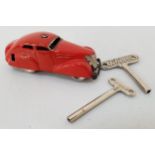 VINTAGE SCHUCO 3000 TINPLATE CAR in red livery with two branded wind up keys