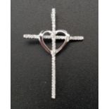 DIAMOND SET CROSS PENDANT with central heart detail, in unmarked white gold, 3.2cm high