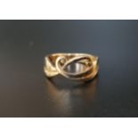 NINE CARAT GOLD SHEILA FLEET 'NEW WAVE' RING of entwined scroll design, ring size L and
