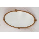 GILT OVAL WALL MIRROR with a plain plate, 72.5cm wide