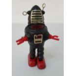 TINPLATE ROBBIE THE ROBOT with a clockwork mechanism by KO of Japan, with a black body, red feet and