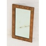 BRASS RECTANGULAR WALL MIRROR with a bevelled plate, the frame embossed with thistles, 54cm x 33.5cm