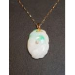 DIAMOND SET JADE PENDANT the carved jade section with central diamond, on fourteen carat gold