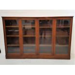 WYLIE & LOCHHEAD SIDE CABINET with a plain top above two pairs of glazed doors, opening to reveal