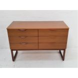 EUROPA TEAK CHEST with an arrangement of six short drawers with roll over handles, standing on