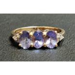 TANZANITE AND DIAMOND RING the three oval cut tanzanites flanked by three small diamonds to each