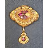 VICTORIAN UNMARKED HIGH CARAT GOLD BROOCH/PENDANT the ornate relief scroll decorated brooch with