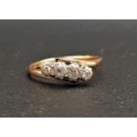 DIAMOND FOUR STONE TWIST DESIGN RING in eighteen carat gold and platinum, the diamonds totaling