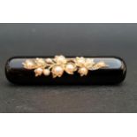 BLACK AGATE AND SEED PEARL MOURNING BROOCH the agate bar with seed pearl set floral decoration,