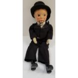 VENTRILOQUIST DUMMY with a moulded plastic head and jointed lower jaw, dressed in a morning coat,