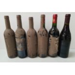 SIX BOTTLES OF UNKNOWN RED WINE all covered in a layer of dirt resulting in the labels being