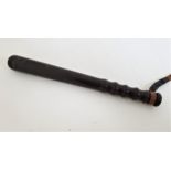 HARDWOOD TRUNCHEON with a ribbed grip and leather wrist strap, 38cm long