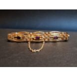 AMETHYST SET NINE CARAT GOLD BRACELET the gate style bracelet with eight bezel set amethysts, with